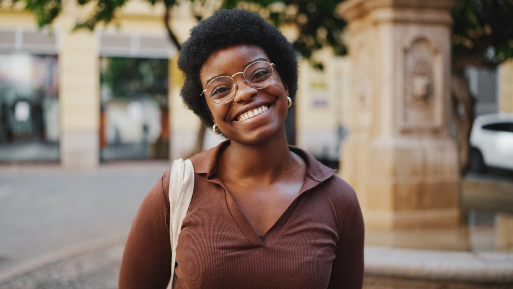 Cheerful African woman with glasses